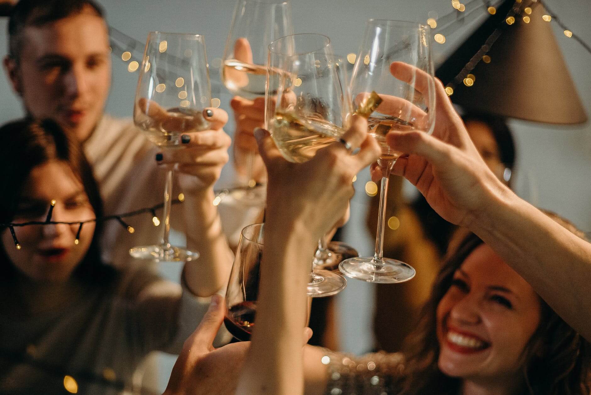people clinking wine glasses